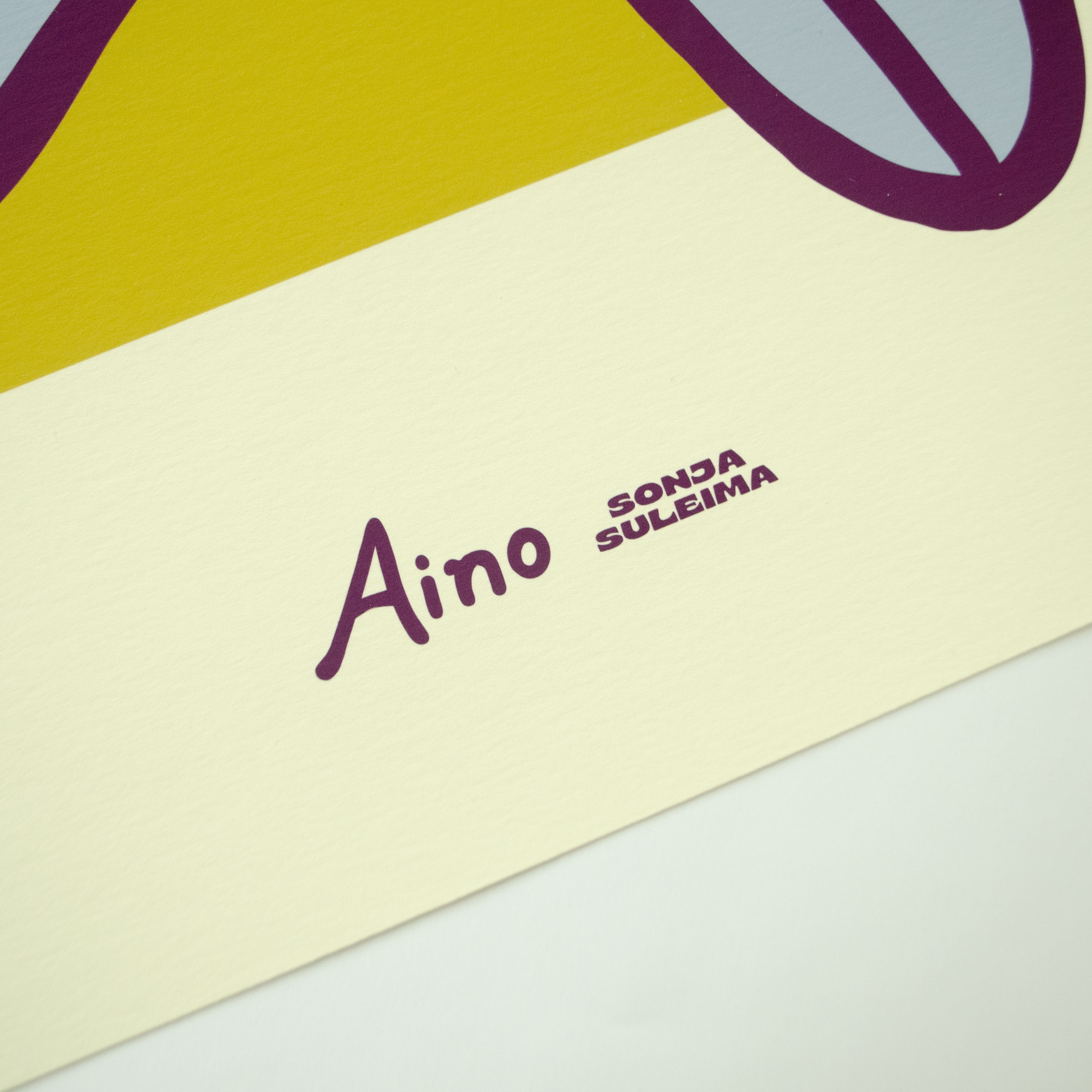Zoomed image of "AINO" text and SONJA SULEIMA logo in the bottom of the art print.